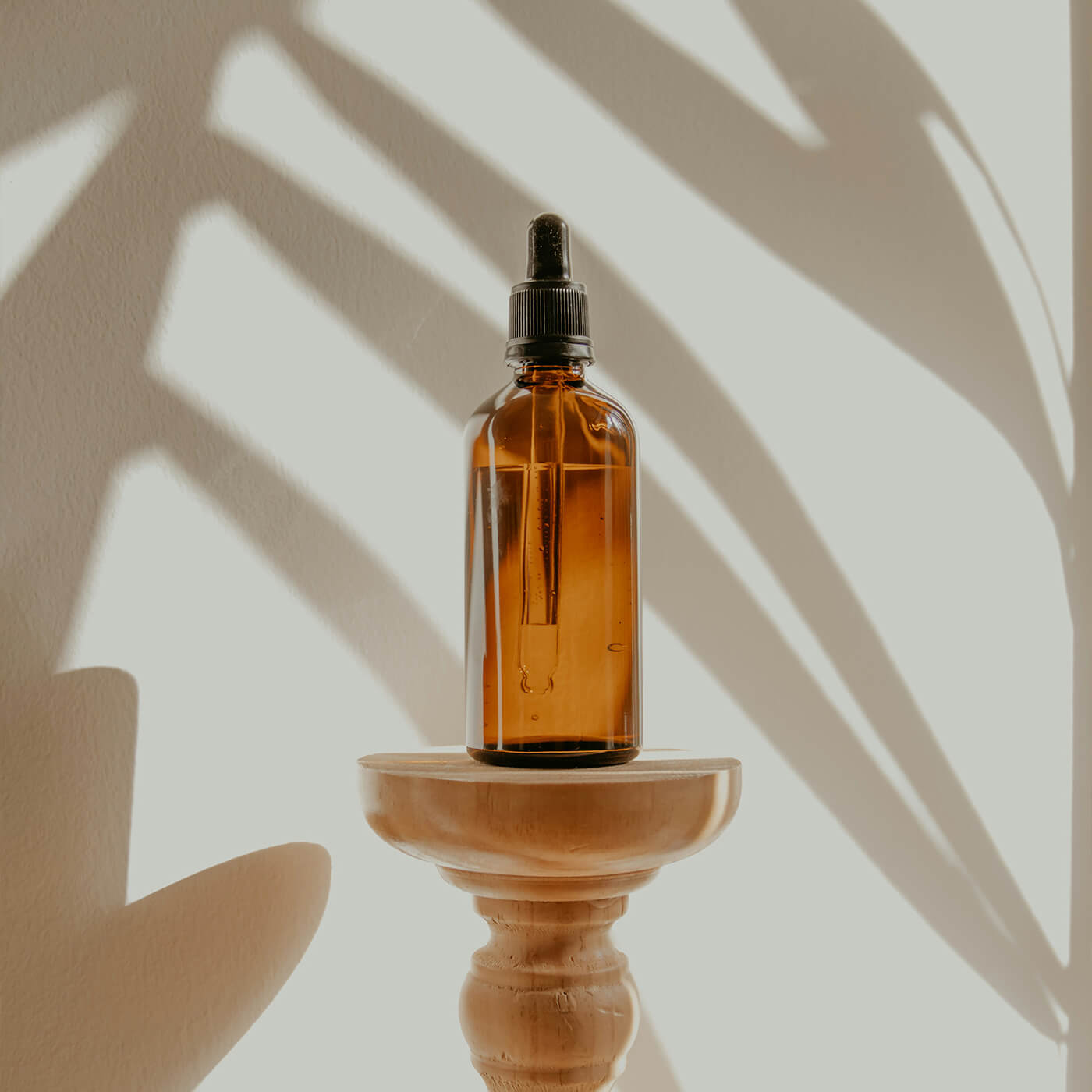 Gold and black bottle on white wooden table